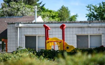 yellow and red plastic toy car on green grass field