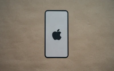 an iphone is sitting on a brown surface