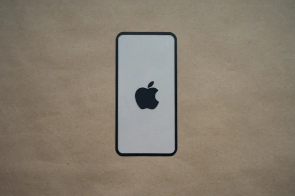 an iphone is sitting on a brown surface