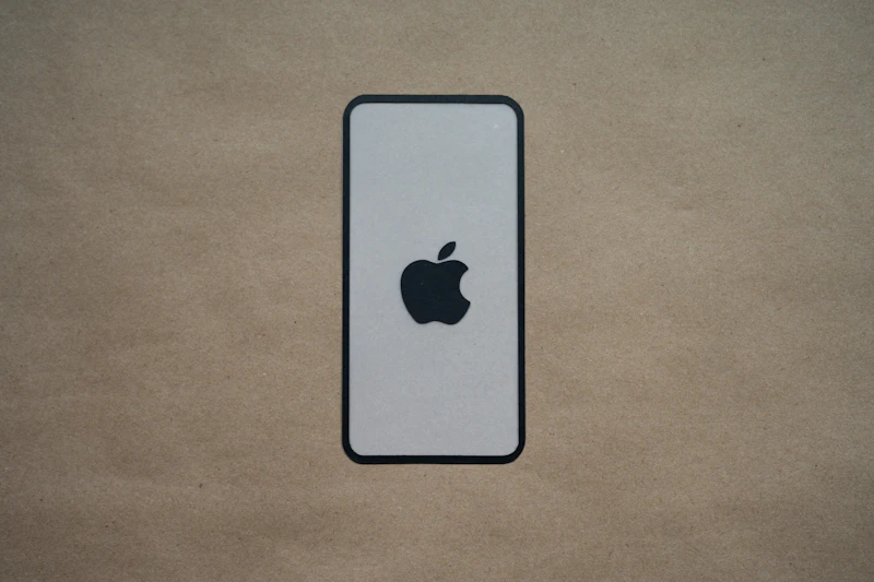 an iphone is sitting on a brown surface