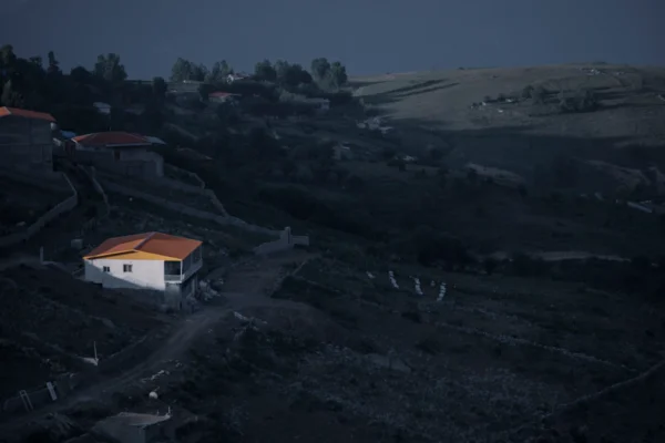 white and brown house on top of hill