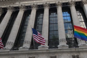 a group of flags flying in front of a building
