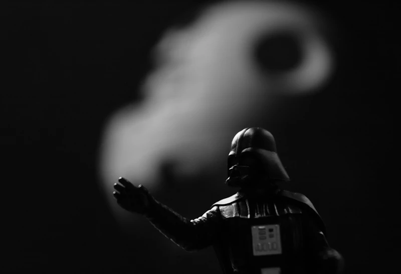 grayscale photo of Star Wars Darth Vader action figure