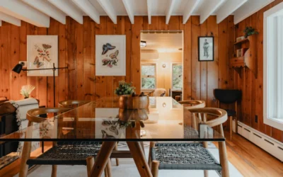 a dining room with wood paneling and a glass table