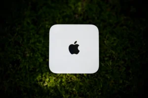 White apple computer on green grass