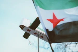 A flag and a cross on a pole