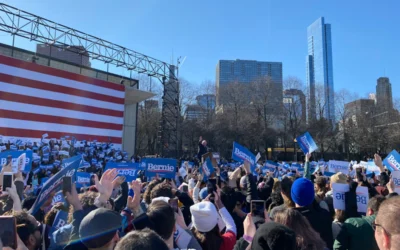 people gathering near us flag during daytime