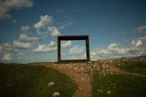 a wooden structure sitting on top of a lush green field