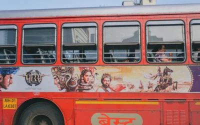 red and white bus with graffiti