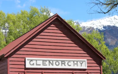 brown wooden house near green trees during daytime