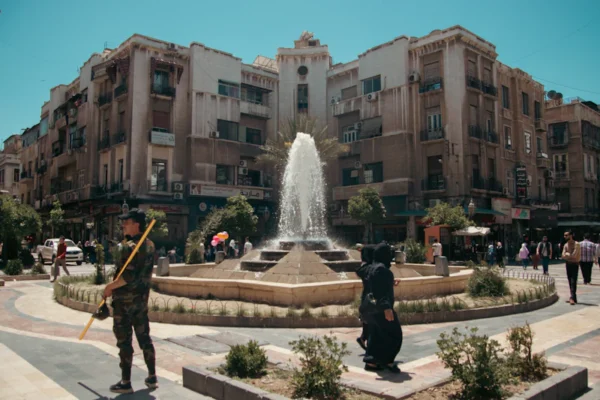 A couple of people that are standing in front of a fountain