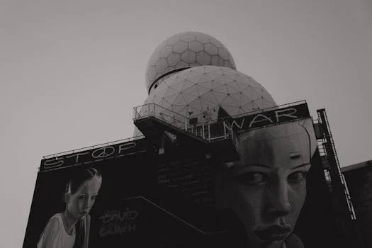 Black and white photo of anti-war mural on Teufelsberg Listening Station in Berlin, emphasizing peace.