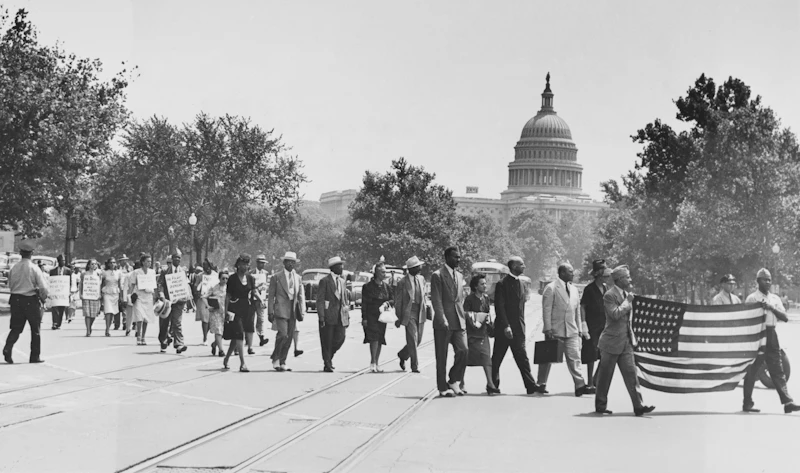Group of African-Americans, marching near the Capitol building in Washington, D.C., to protest the lynching of four African-Americans in Georgia.