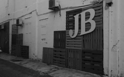a black and white photo of a building with a jb sign on it