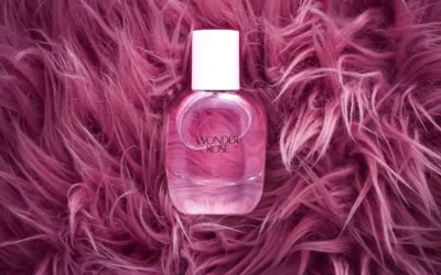 A stylish pink perfume bottle on a plush, pink fur background, exuding elegance and luxury.