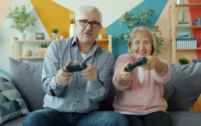 Elderly couple playing video games together on couch