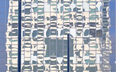 the reflection of a building in the windows of another building