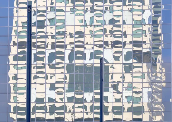 the reflection of a building in the windows of another building