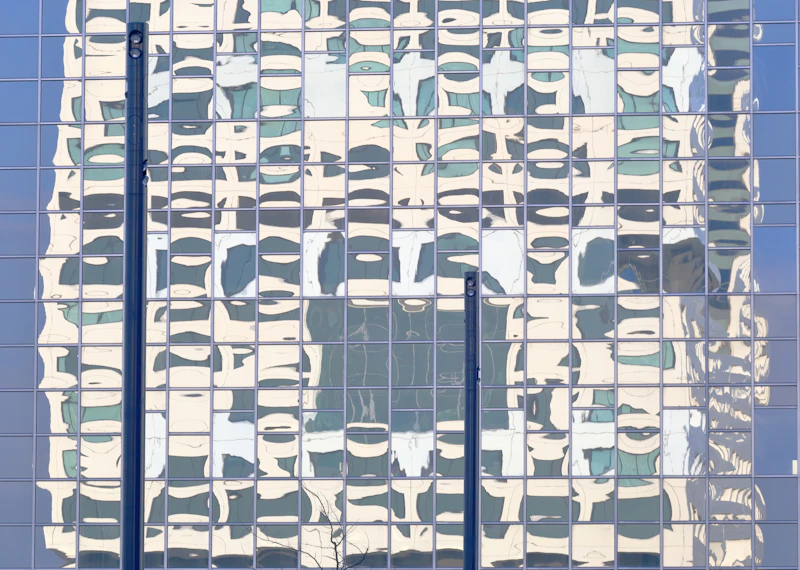 the reflection of a building in the windows of another building