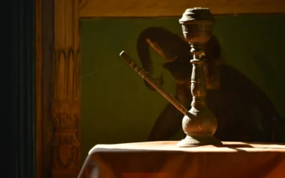 brass-colored teapot on table