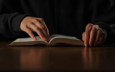 a person is reading a book on a table