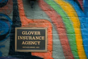 a sign on a brick wall that says glover insurance agency
