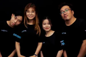 Four diverse young adults in META logo T-shirts against a black background.