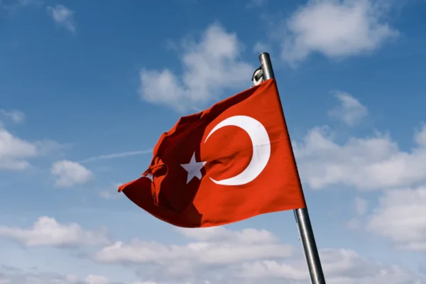 a red and white flag flying in the wind