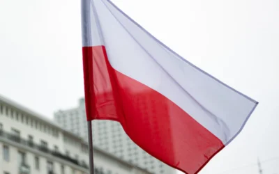 The polish flag waves in the breeze.