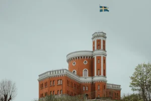 a large brick building with a flag on top of it