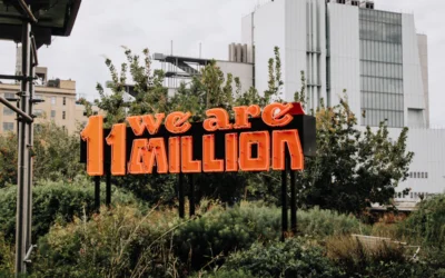 we are 11 million sign on green grass