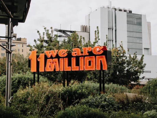 we are 11 million sign on green grass