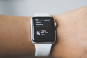 person wearing silver aluminum case Apple Watch with white Sport Band