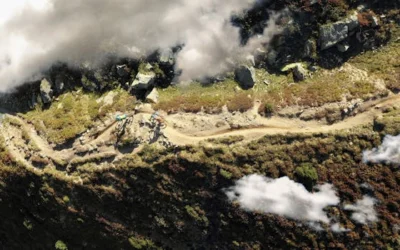 Drone shot of cyclists biking on a scenic mountain trail in Davos, Switzerland.