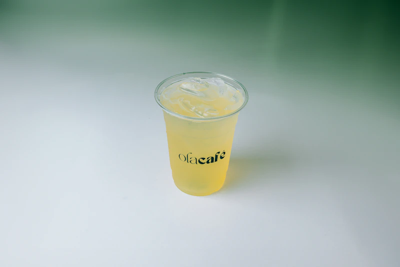 A plastic cup with a drink inside of it