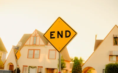 a yellow end sign sitting on the side of a road