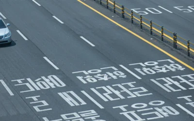 A car driving down a street next to a traffic light