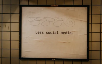 a sign on a wall that says less social media