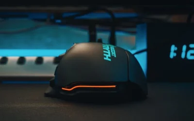 Close-up of a futuristic gaming mouse next to a digital clock, showcasing modern technology.