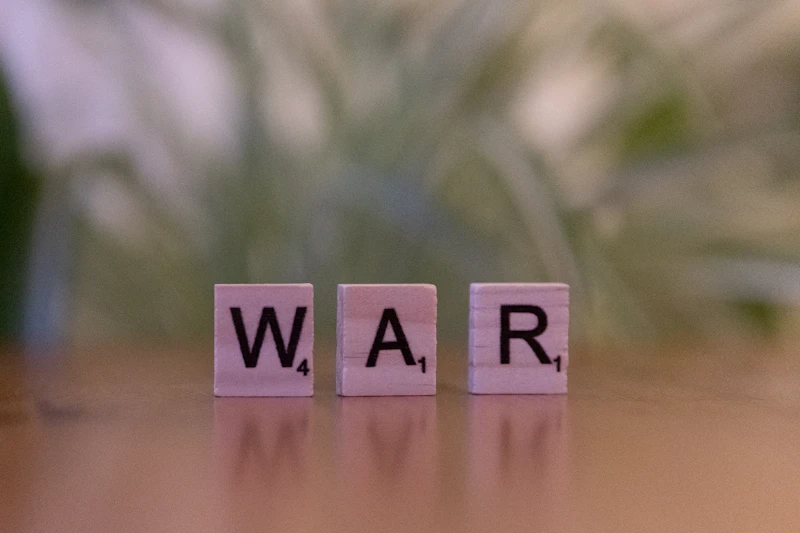A wooden block spelling war on a table