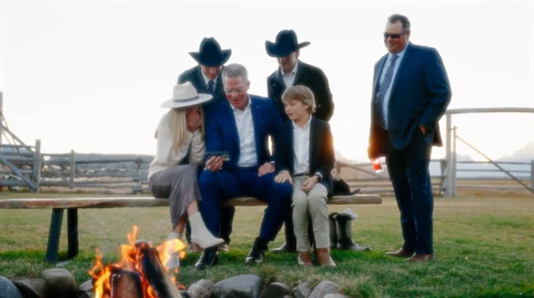 a group of people sitting around a fire pit