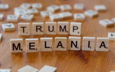 Scrabble tiles spelling out the words trump, melanin, and y