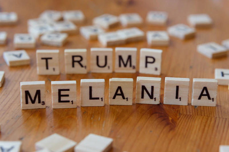 Scrabble tiles spelling out the words trump, melanin, and y