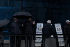 people standing under umbrellas