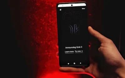 A hand holds a smartphone displaying Grok 3 announcement against a red background.