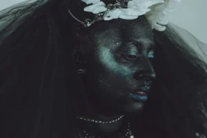 Woman with dark face paint and glitter