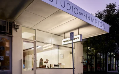 A store front with a street sign in front of it