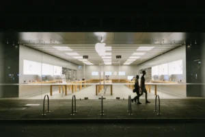 man and woman passing by store