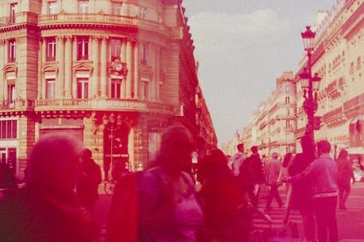 Crowded street scene with people and historic buildings in a vibrant city setting.