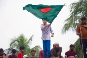 A woman holding a green and red flag